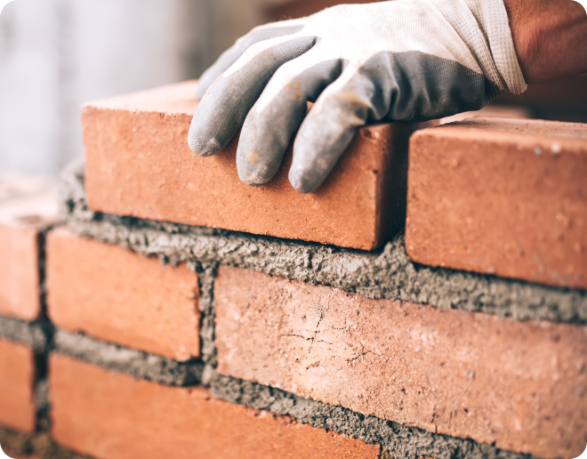 close-up-of-industrial-bricklayer-installing-bricks-on-construction